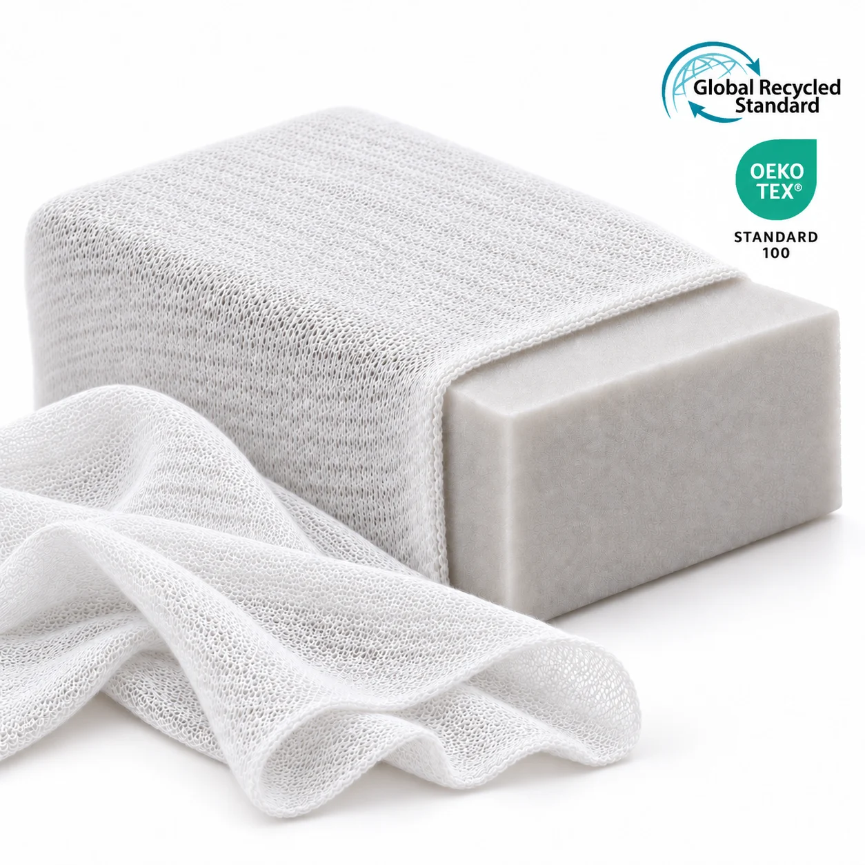 Foam block wrapped in white stretch stockinette, with loosely laid stockinette beside it